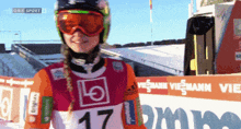 a woman wearing goggles and the number 17