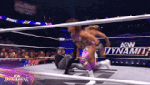 a woman in a purple outfit is in a wrestling ring with the words aew dynamite in the background