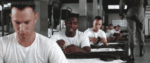 a group of soldiers are sitting at tables in a room with the words " introvertgifs " on the bottom right