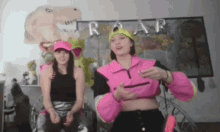 two girls are standing in front of a sign that says roar