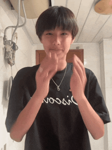 a young man wearing a black shirt that says ' moscow ' on it