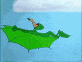 a cartoon character is flying through the air on a green umbrella .