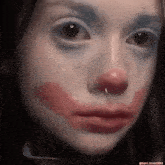 a close up of a woman 's face with makeup on it