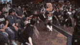 a woman is dancing in front of a crowd of people .