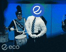 a man in a marching band playing drums with a blue circle with the letter e on it