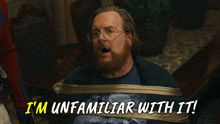 a man with a beard and glasses is tied up and says i 'm unfamiliar with it