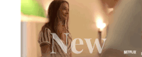 a woman is standing in front of a sign that says " new " on it