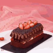 a chocolate cake with strawberries and chocolate frosting on top