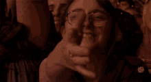 a woman with glasses is making a funny face in front of a sign that says ' i like you '