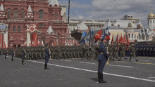 a group of soldiers marching in front of a building that says ' embassy of russia ' on it