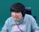 a man is wearing headphones and making a funny face