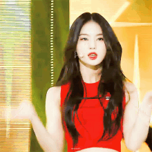 a woman in a red crop top with the word mama on the bottom