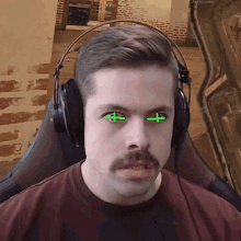 a man with a mustache wearing headphones has green crosses in his eyes