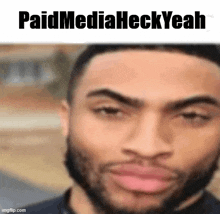 a close up of a man 's face with a beard and the words `` paid media heck yeah '' .