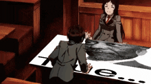a man and a woman are sitting at a table with a picture of a man 's face on it and the number 7 on it