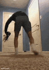 a person is doing a handstand in front of a door