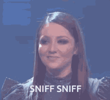 a close up of a woman 's face with the words sniff sniff on the bottom