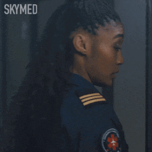 a woman in a blue uniform with the word skymed on the bottom