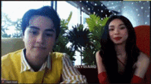 a man and a woman are sitting next to each other on a video call with mayward written on the screen