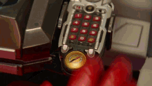 a person is holding a toy phone with a compass on it