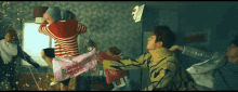 a group of people are having a pillow fight in a bedroom