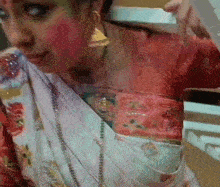 a woman in a red and white dress is holding a white box