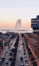 an aerial view of a busy city street with a water fountain in the background and a building that says ' bvlgari '