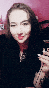 a woman taking a selfie with a phone in her hand