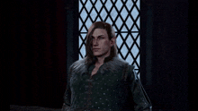a man with long hair and elf ears is smiling