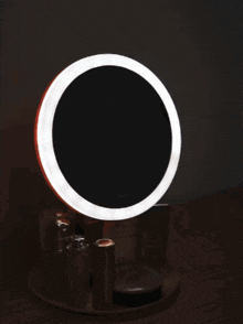 a round mirror with a light on it and chinese writing on the bottom