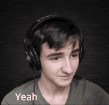 a young man wearing headphones says " yeah " in the corner