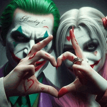 a joker and harley quinn are making a heart shape with their hands