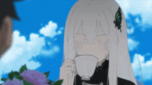 a girl with white hair is drinking from a cup