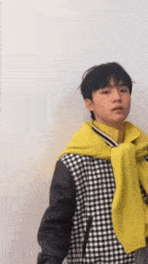 a man wearing a yellow scarf around his neck