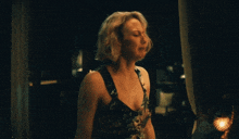a woman in a floral dress is laughing with her head turned