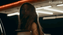 a woman with long hair is standing in a dark room with the hashtag #crypttv