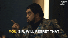 a man in a suit says " you sir will regret that " while pointing