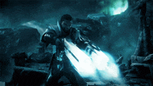 a man in armor is holding a sword that is glowing blue