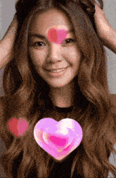 a woman with long hair has a pink heart on her face
