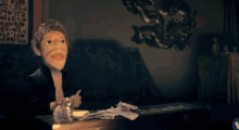 a puppet is sitting on a couch next to a table with money