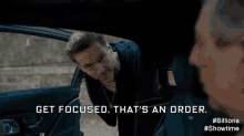 a man in a car with the words get focused that 's an order on the screen
