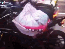 a motorcycle with a bag on the back of it