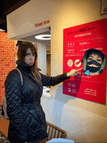 a woman points to a sign that says missing kids museum