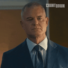 a man in a suit and tie with the word countdown on the bottom
