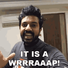 a man with a beard is giving a thumbs up and says " it is a wrrraaap "