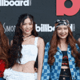 a group of women are posing for a photo in front of a billboard sign