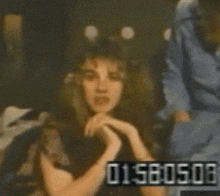 a blurred image of a woman with the numbers 01580516 on the bottom