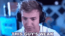 a man wearing headphones says `` this guy 's weak '' while playing a video game .