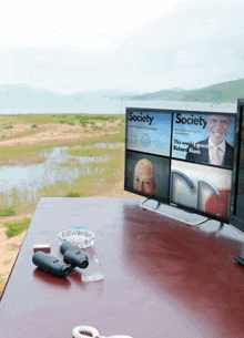 a society magazine is displayed on a monitor