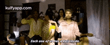 a group of people are dancing in a living room with the words `` each one of us has a kall inside '' .